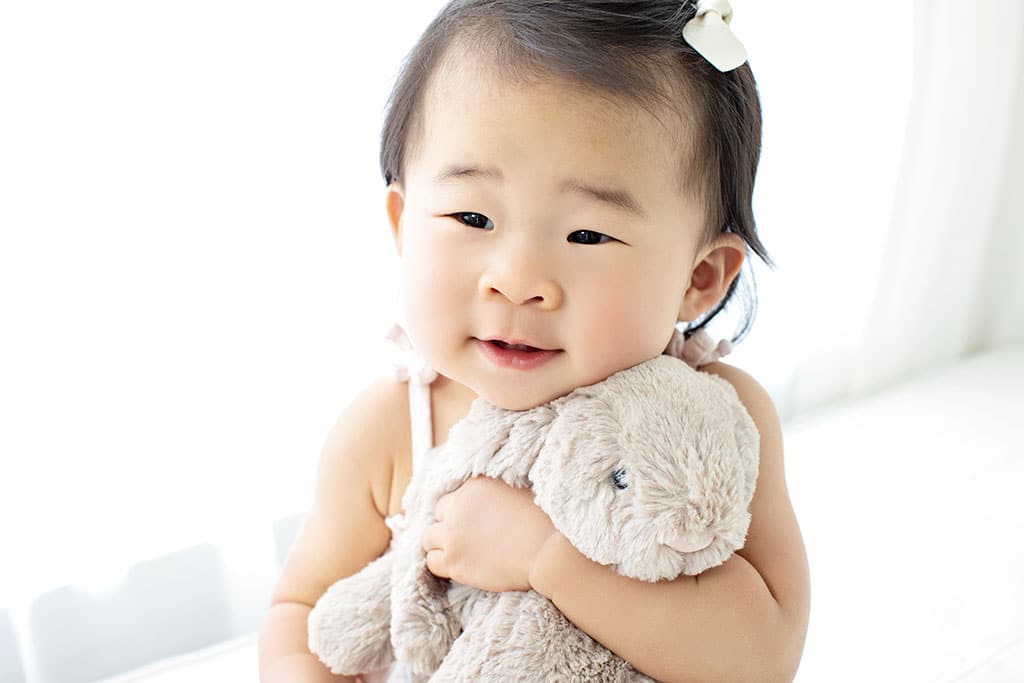 adorable one year old snuggled up with a bunny in private dallas studio