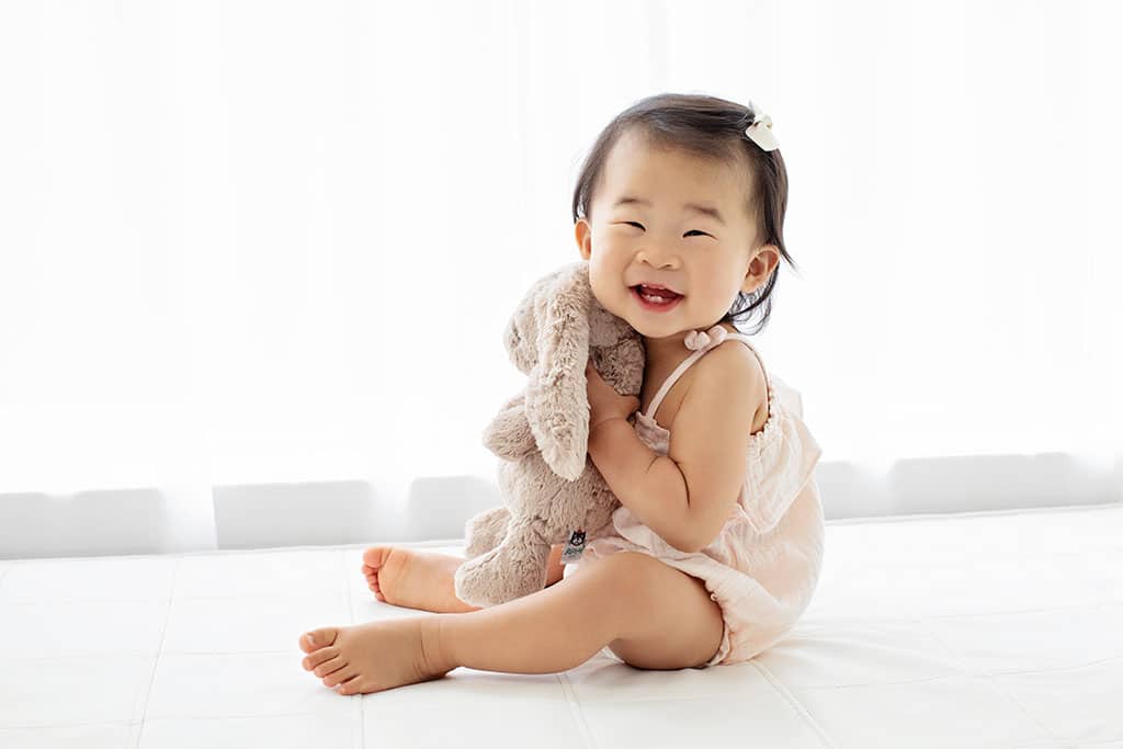 adorable one year old snuggled up with a bunny in private dallas studio