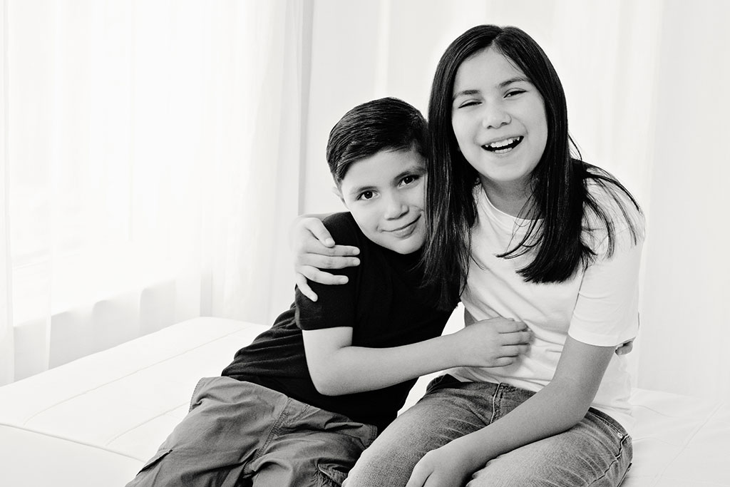 brother and sister posing in adorable studio session