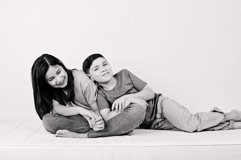 brother and sister posing in adorable studio session