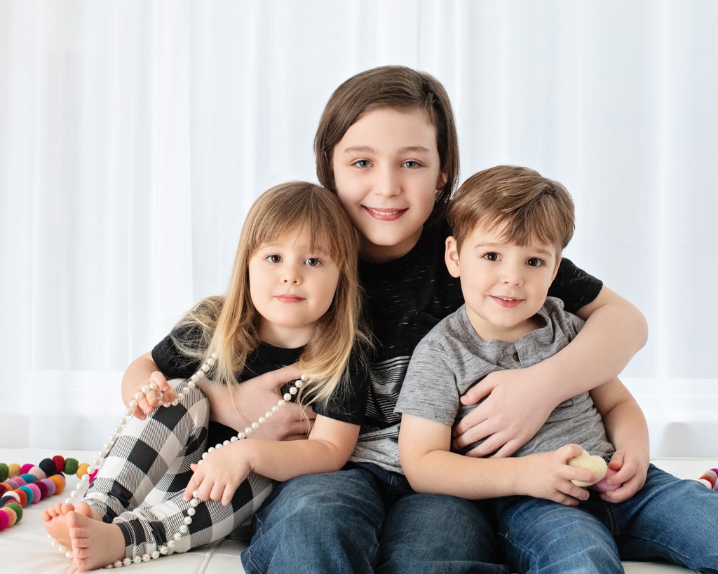 beautiful siblings cuddle up in studio session