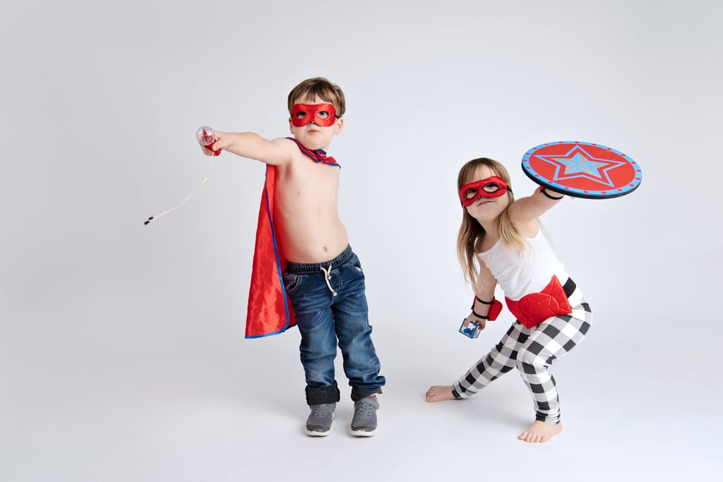 Siblings dressed as superhero's play around in private studio session