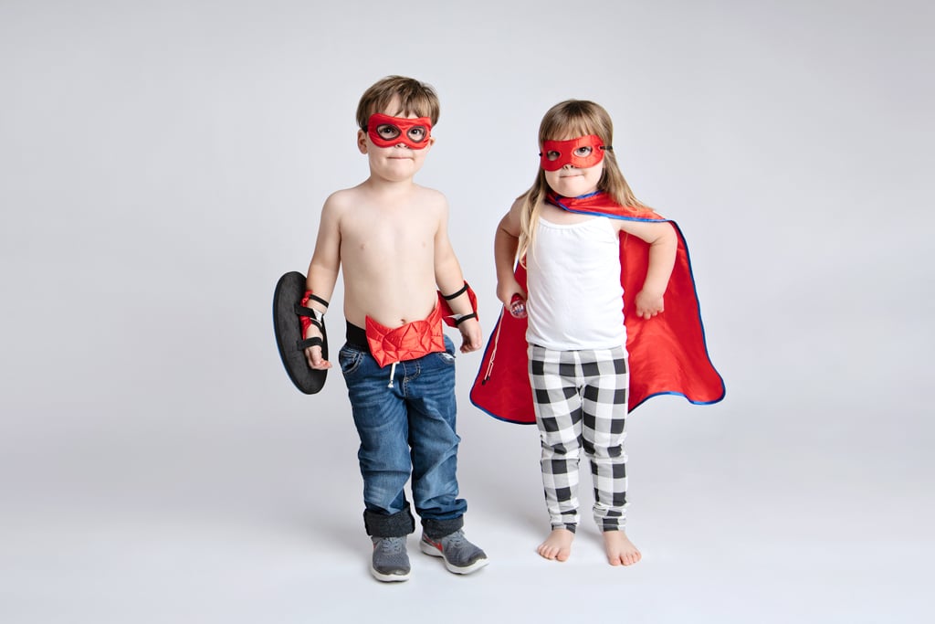 Siblings dressed as superhero's play around in private studio session