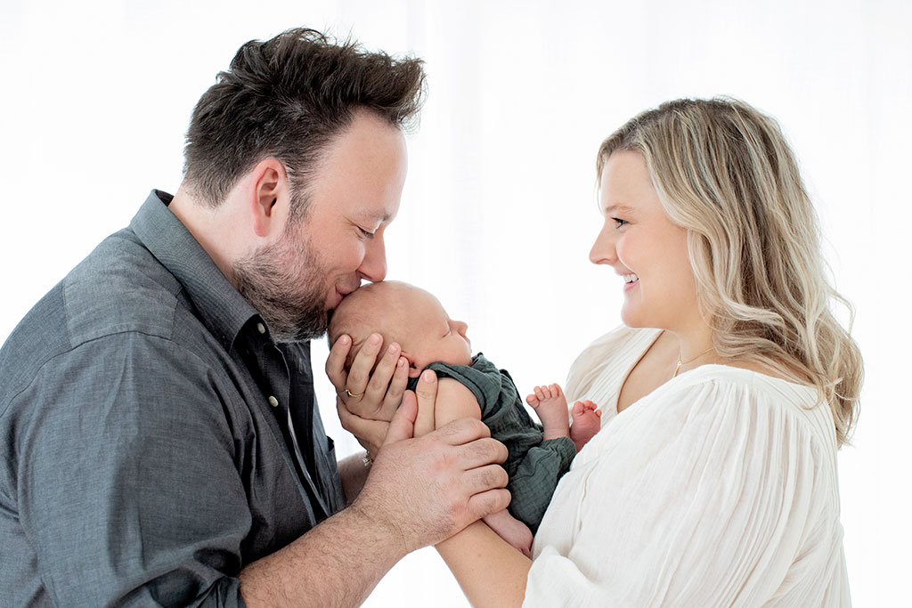 smitten parents holding and loving baby boy