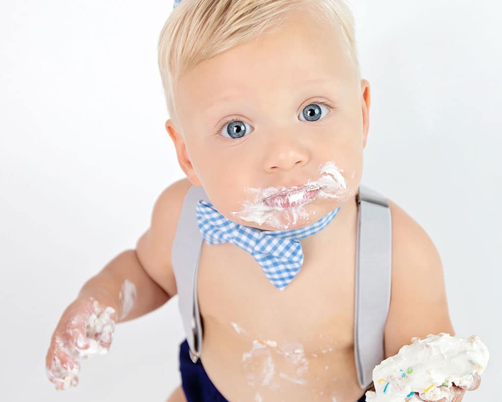 baby boy chows down on first birthday cake