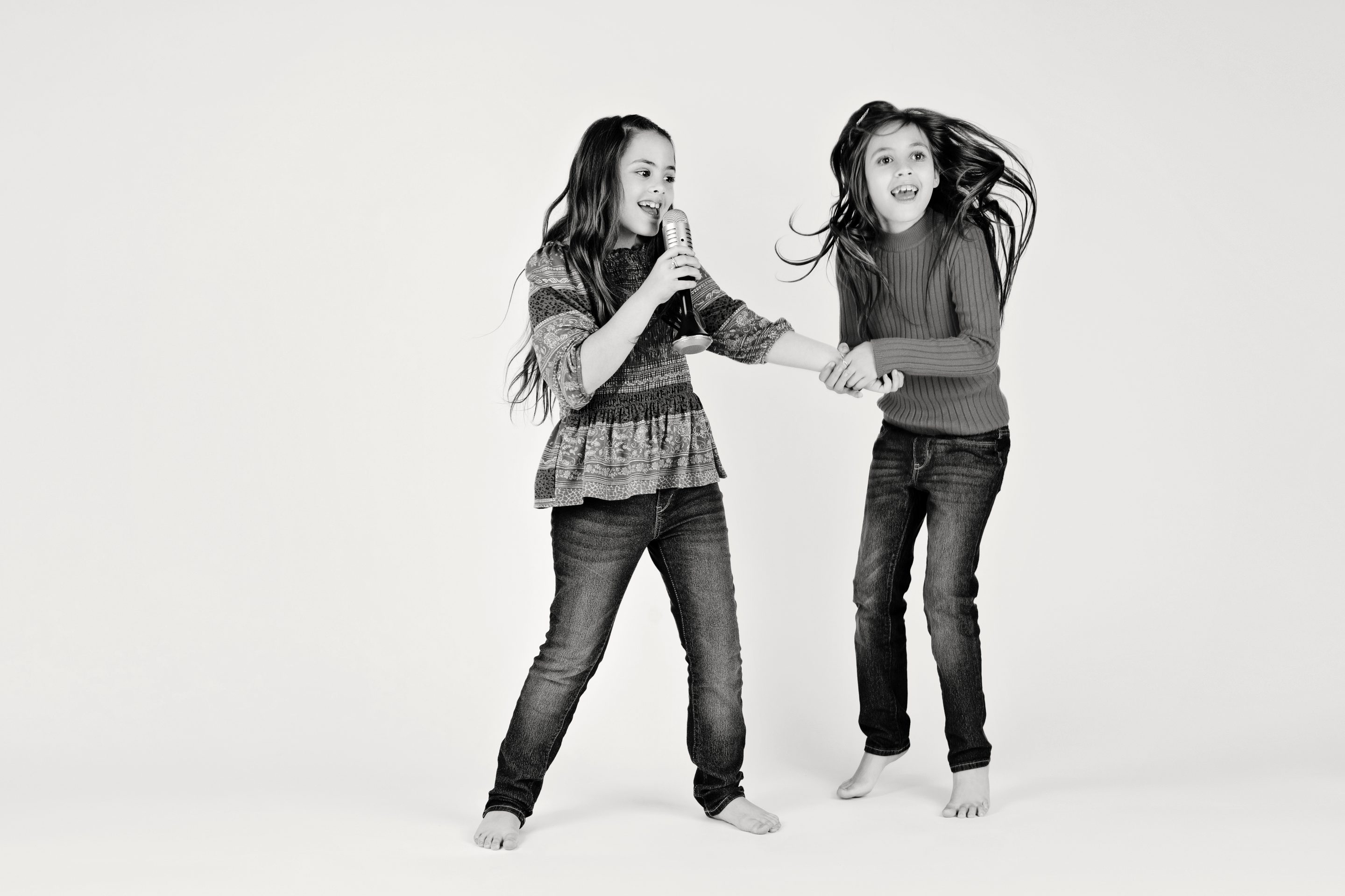 Sisters jumping around and having a blast in the studio