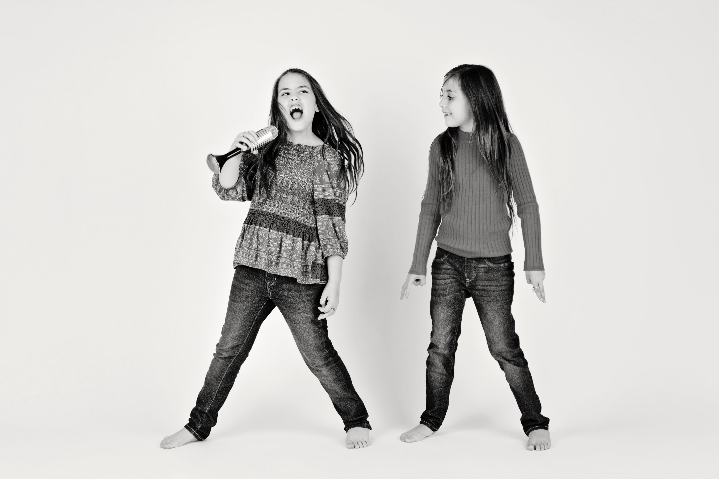 Sisters jumping around and having a blast in the studio