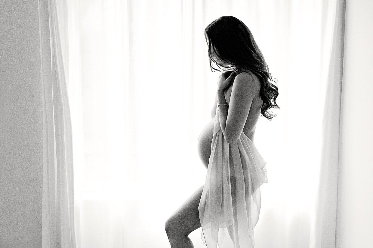 woman expecting child in dallas studio for maternity boudoir session