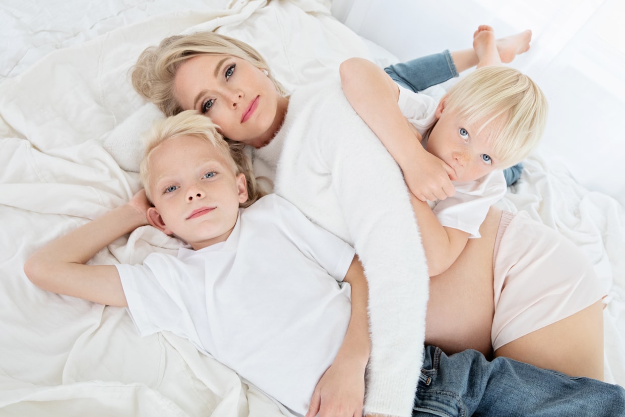mom models with her two boys in preparation for newest family members arrival