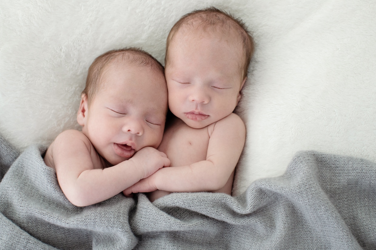 newborn twins cuddled up in studio newborn session