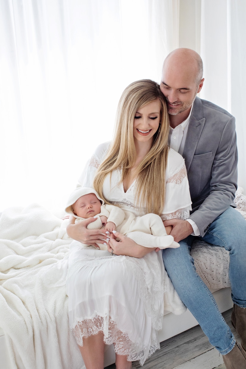 Mom and dad staring at their gorgeous newborn in studio session