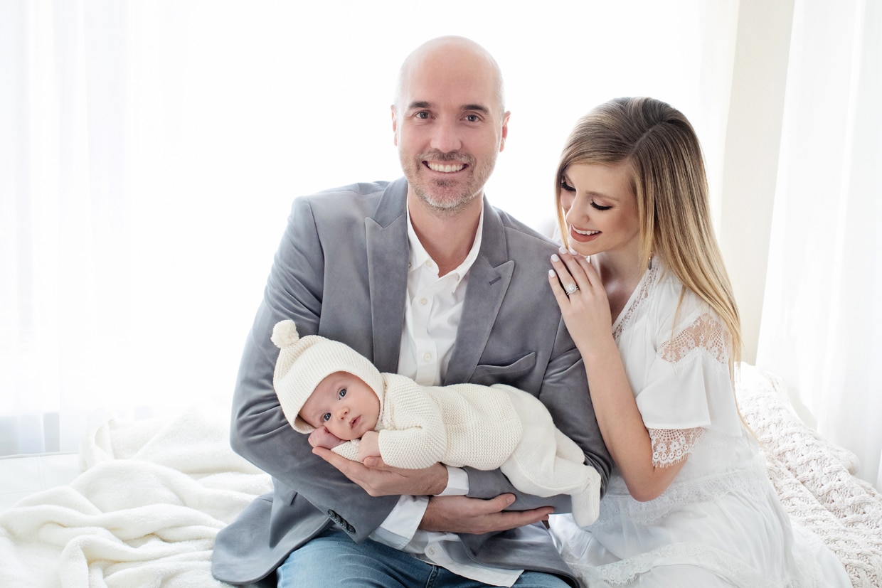 mom and dad loving on their newborn in timeless session