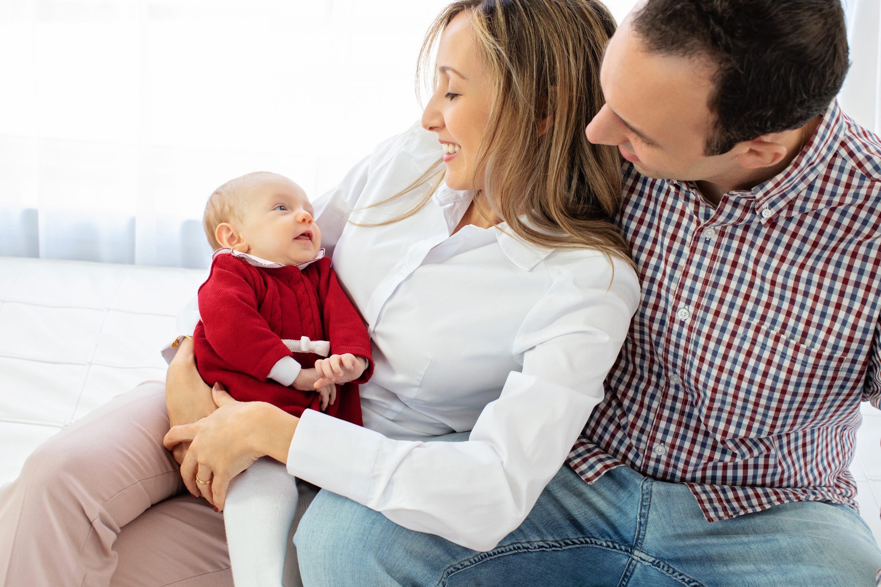 generations of family gather and celebrate newborn baby