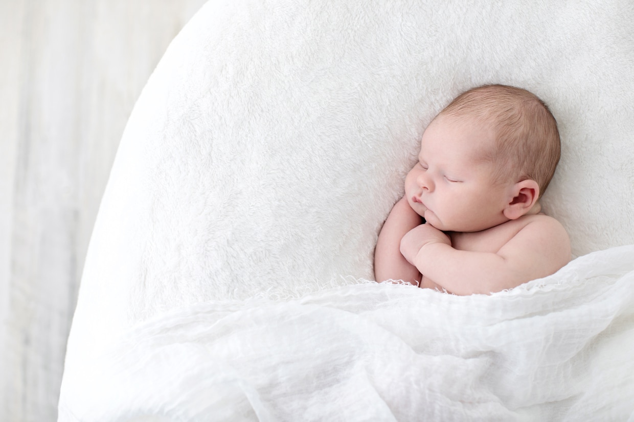 cute baby boy poses in angelic private studio