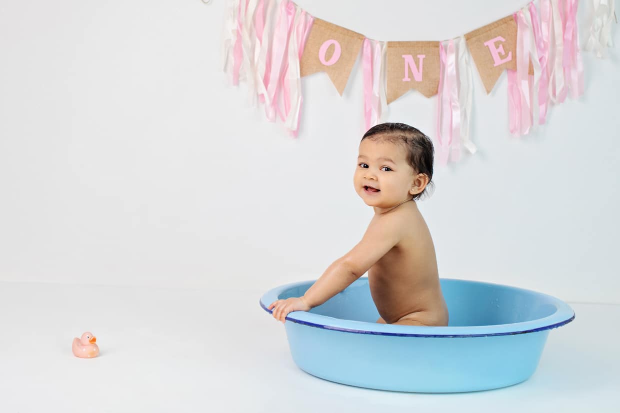 The cutest one year old session with cake smash and tub