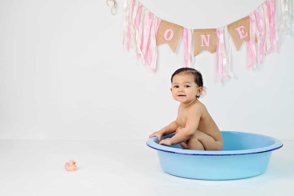 The cutest one year old session with cake smash and tub