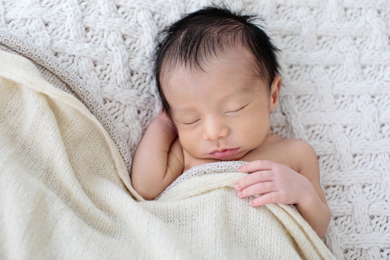 snuggled up newborn in dallas studio session