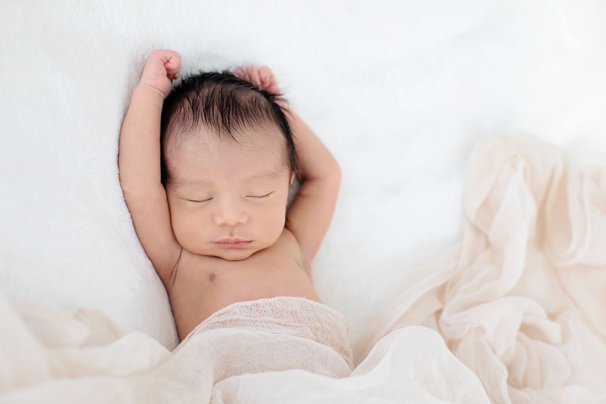 snuggled up newborn in dallas studio session