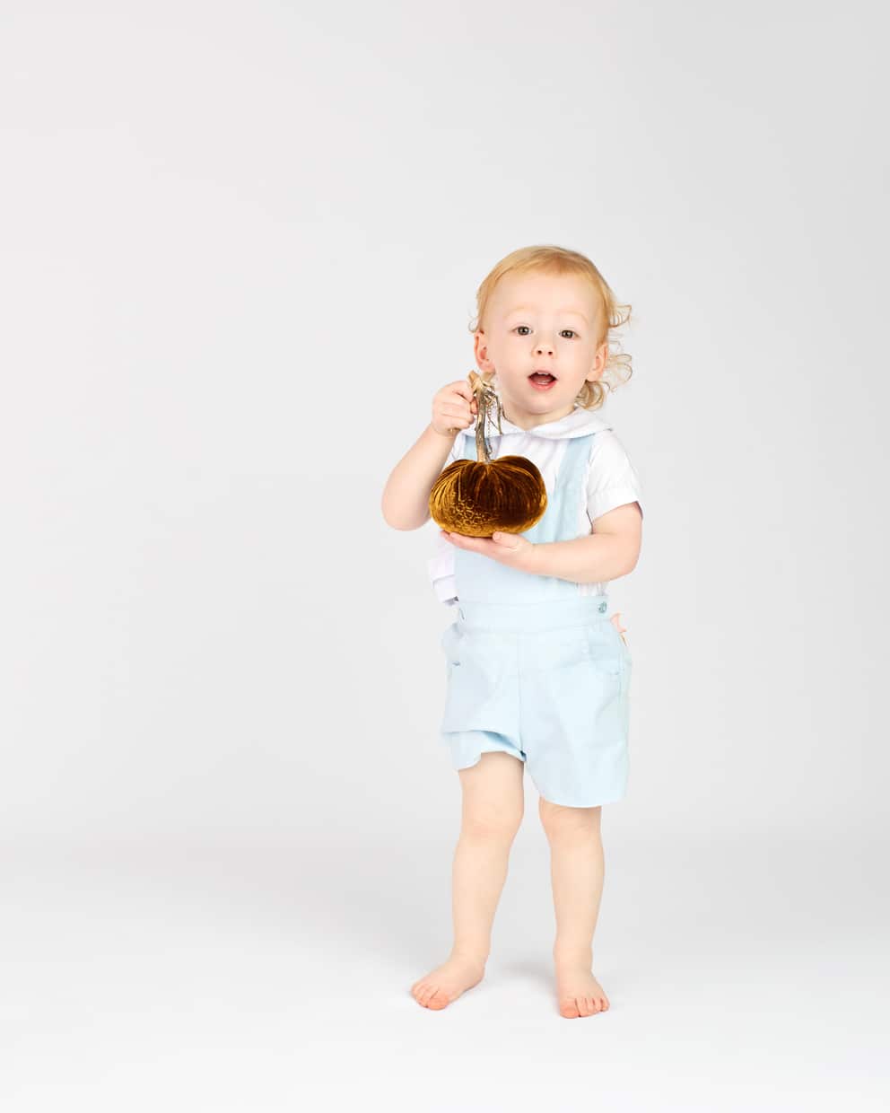 Little boy posing for holiday photos in dallas studio session