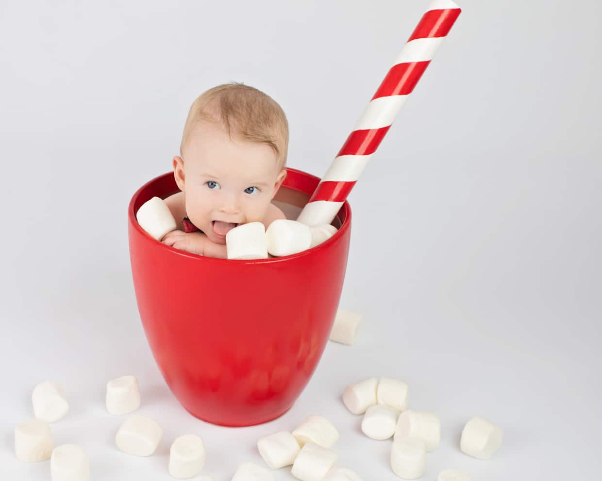 cute baby posing in oversized coffee mug at private dallas studio