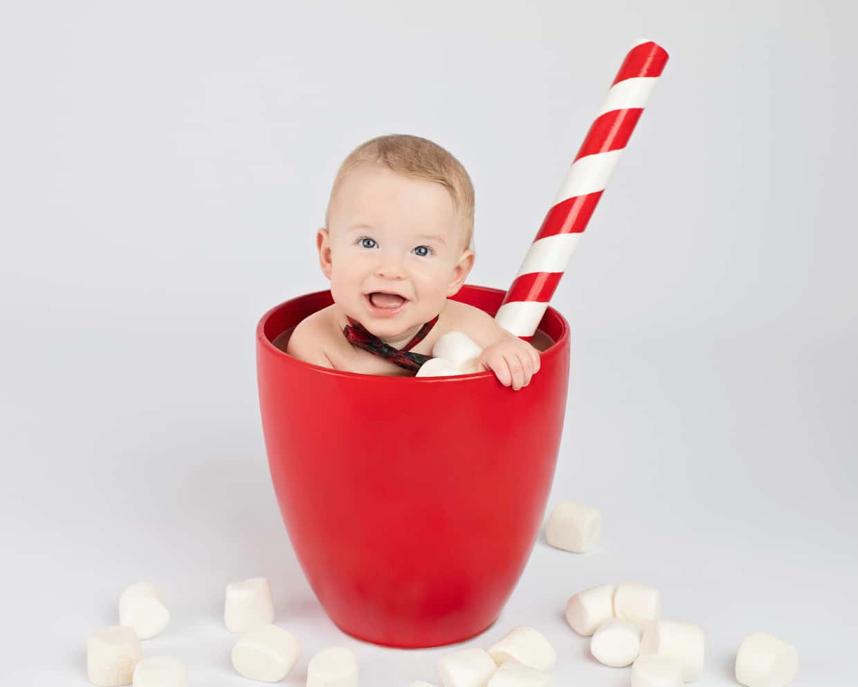 cute baby posing in oversized coffee mug at private dallas studio