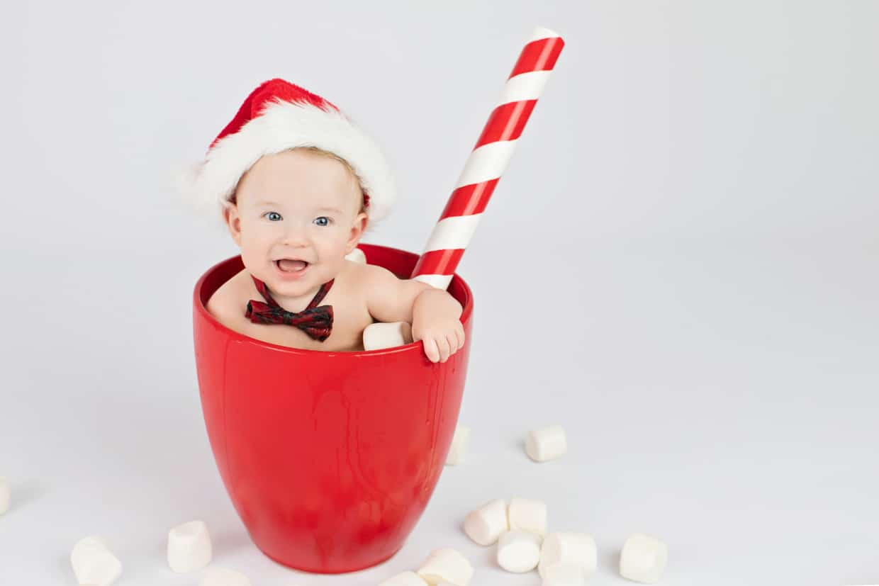 cute baby posing in oversized coffee mug at private dallas studio