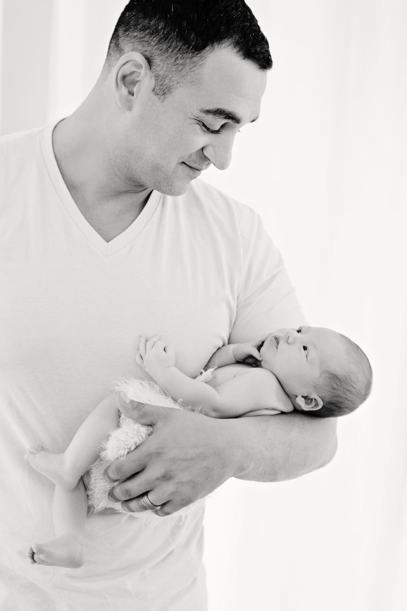 new dad holds baby in private dallas studio session