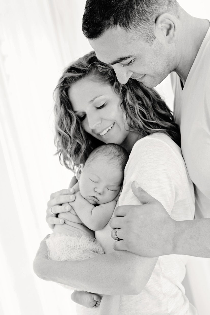 New Mom and Dad in baby bliss during newborn session