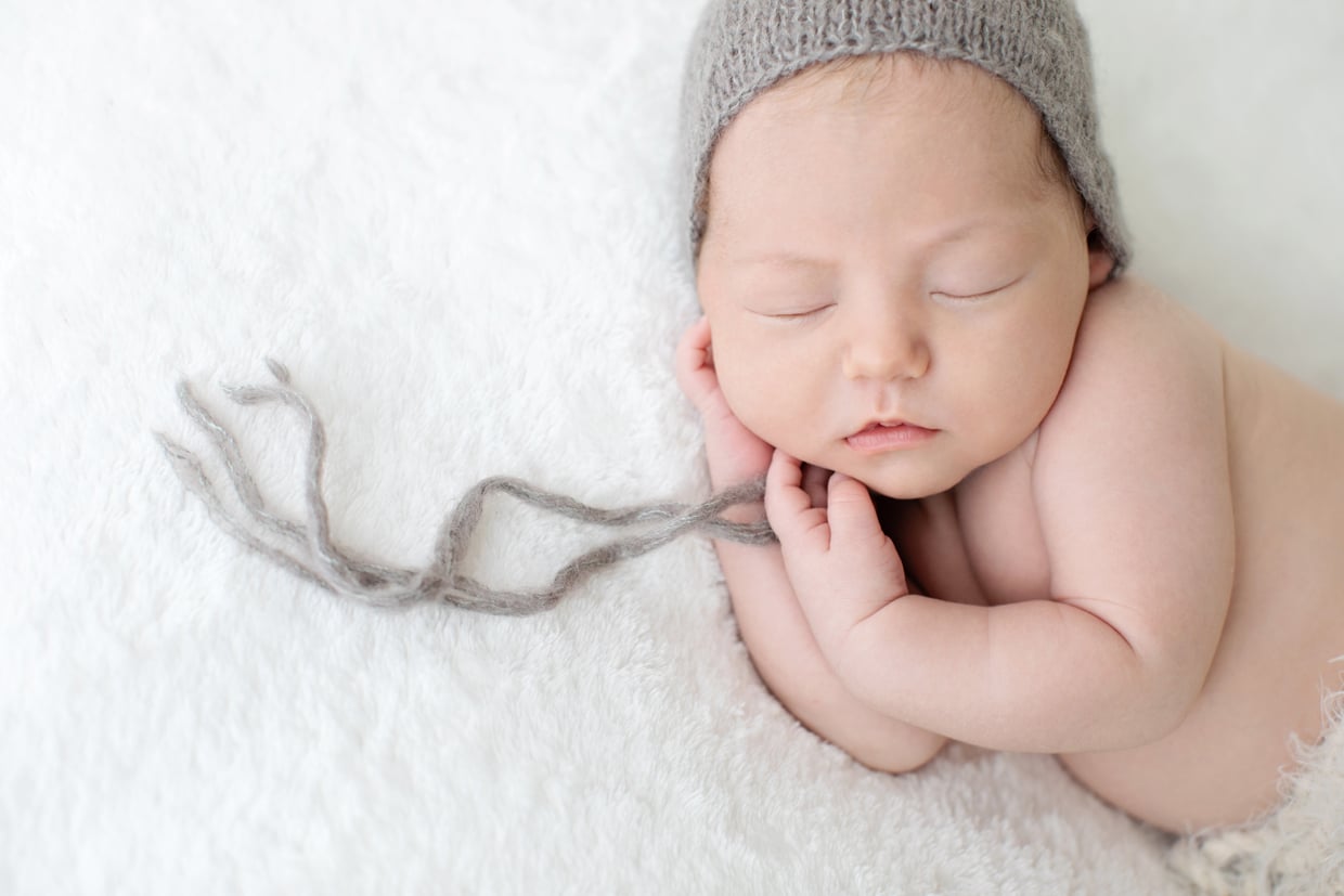 close-up of newborn baby in knit hat