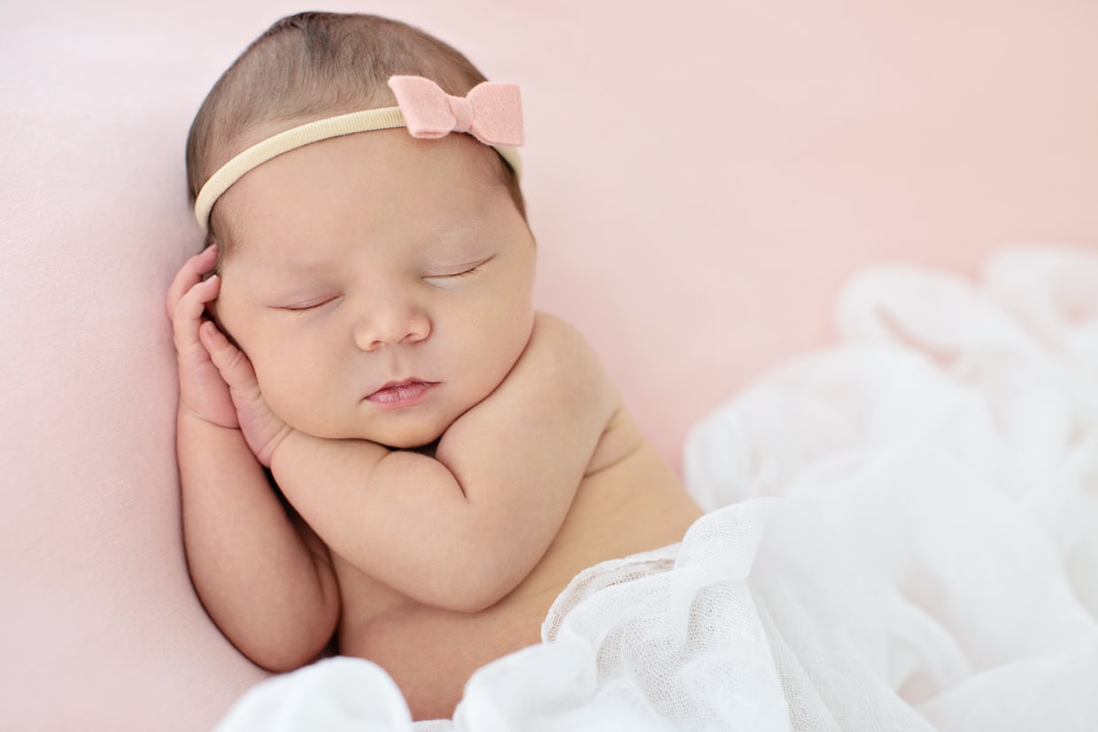 cutest newborn celebrating the season of love in the studio on pink backdrop