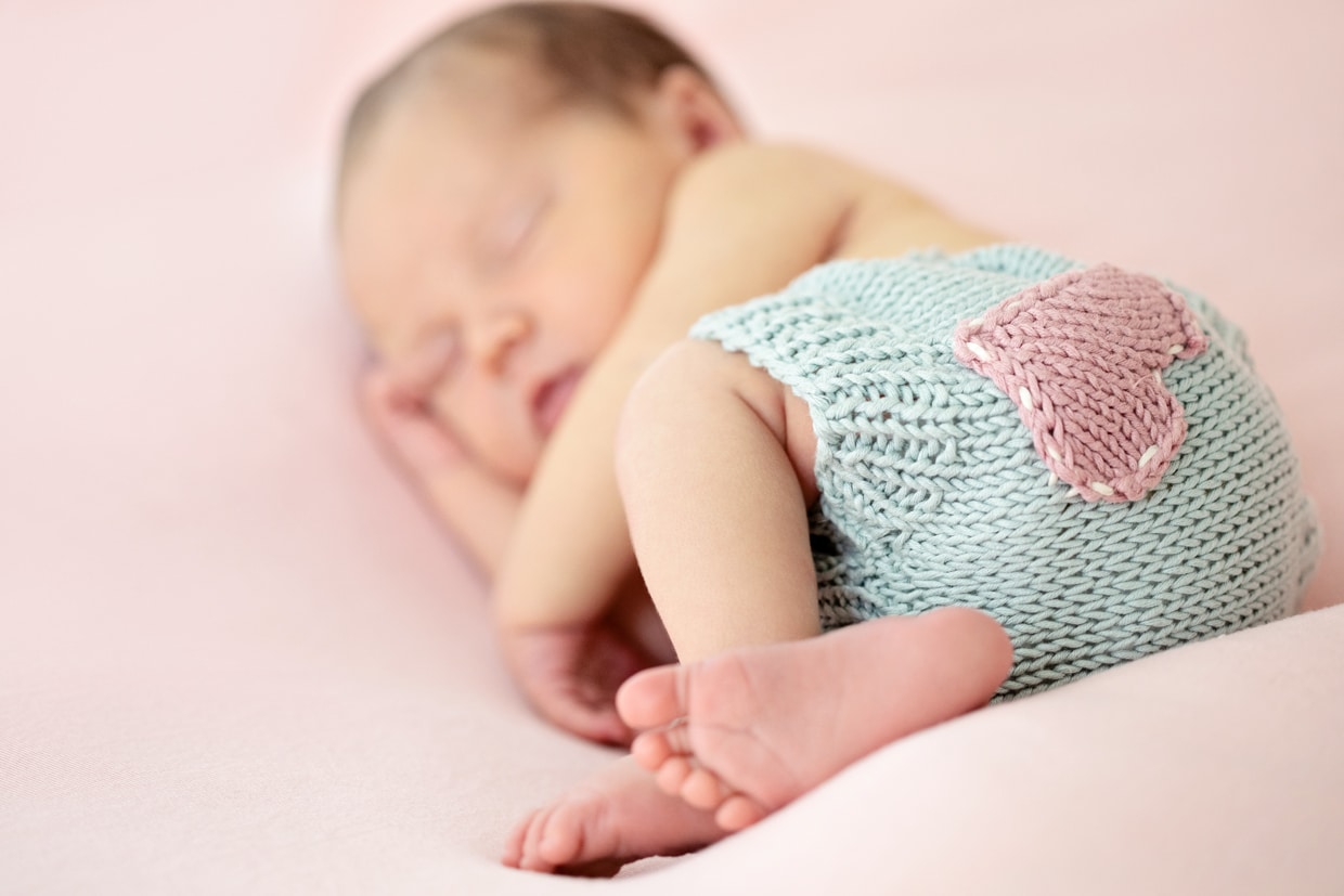 cutest newborn celebrating the season of love in the studio on pink backdrop