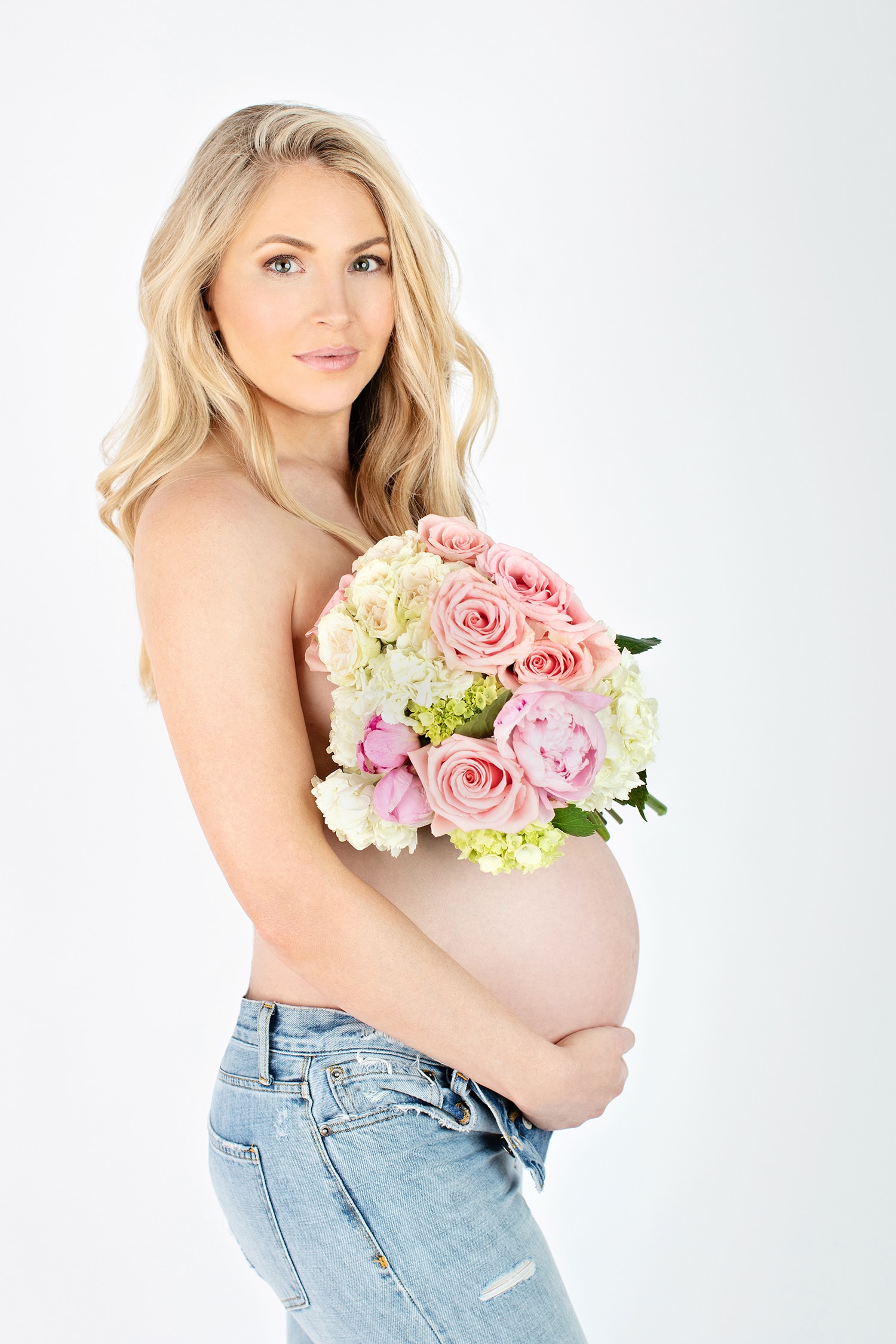 boudoir maternity photo of woman with flowers