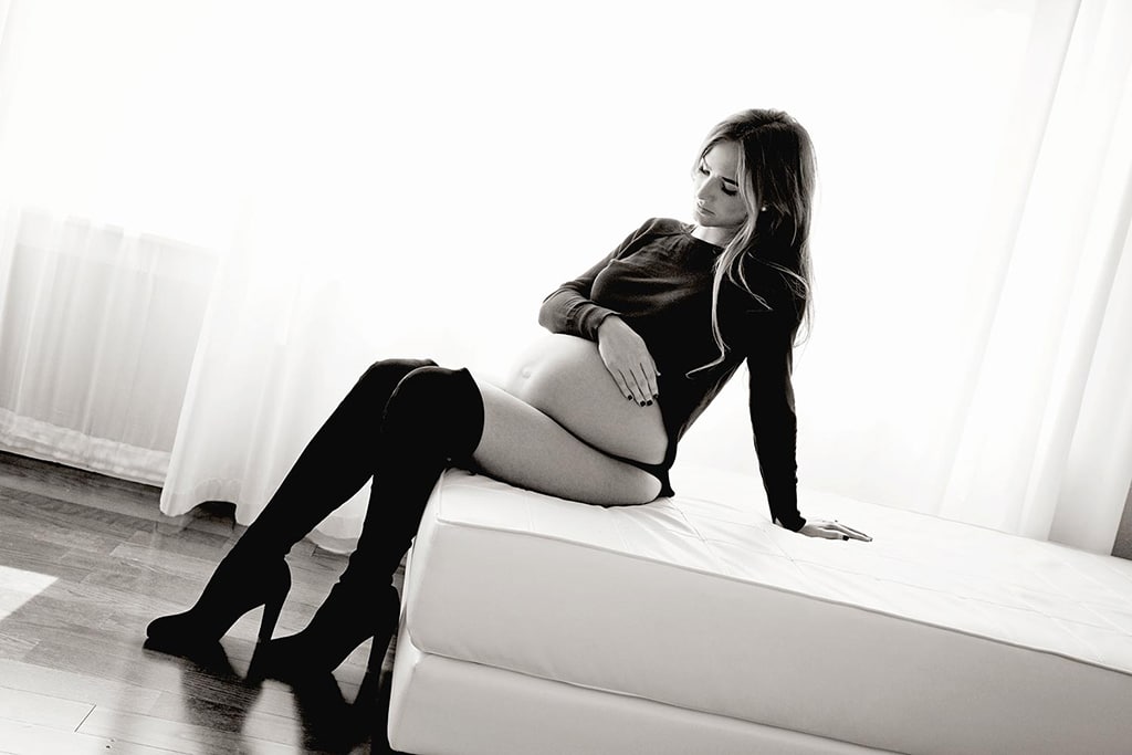 boudoir maternity photo of woman in black boots