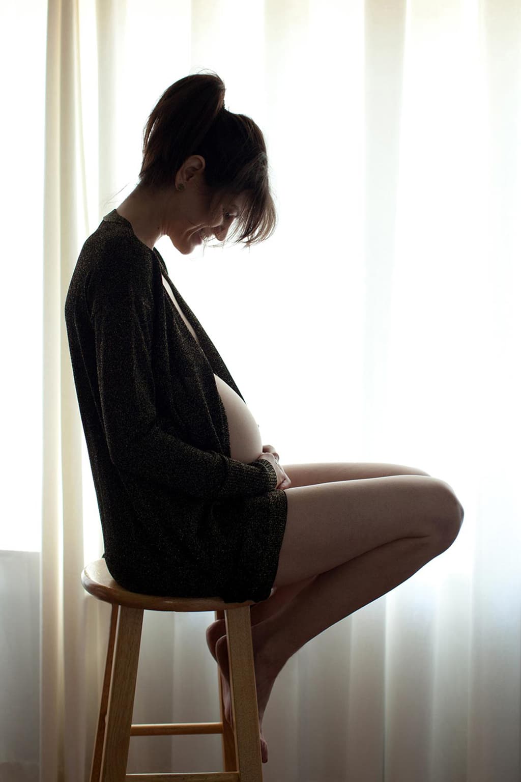 modest maternity photo of woman in black robe