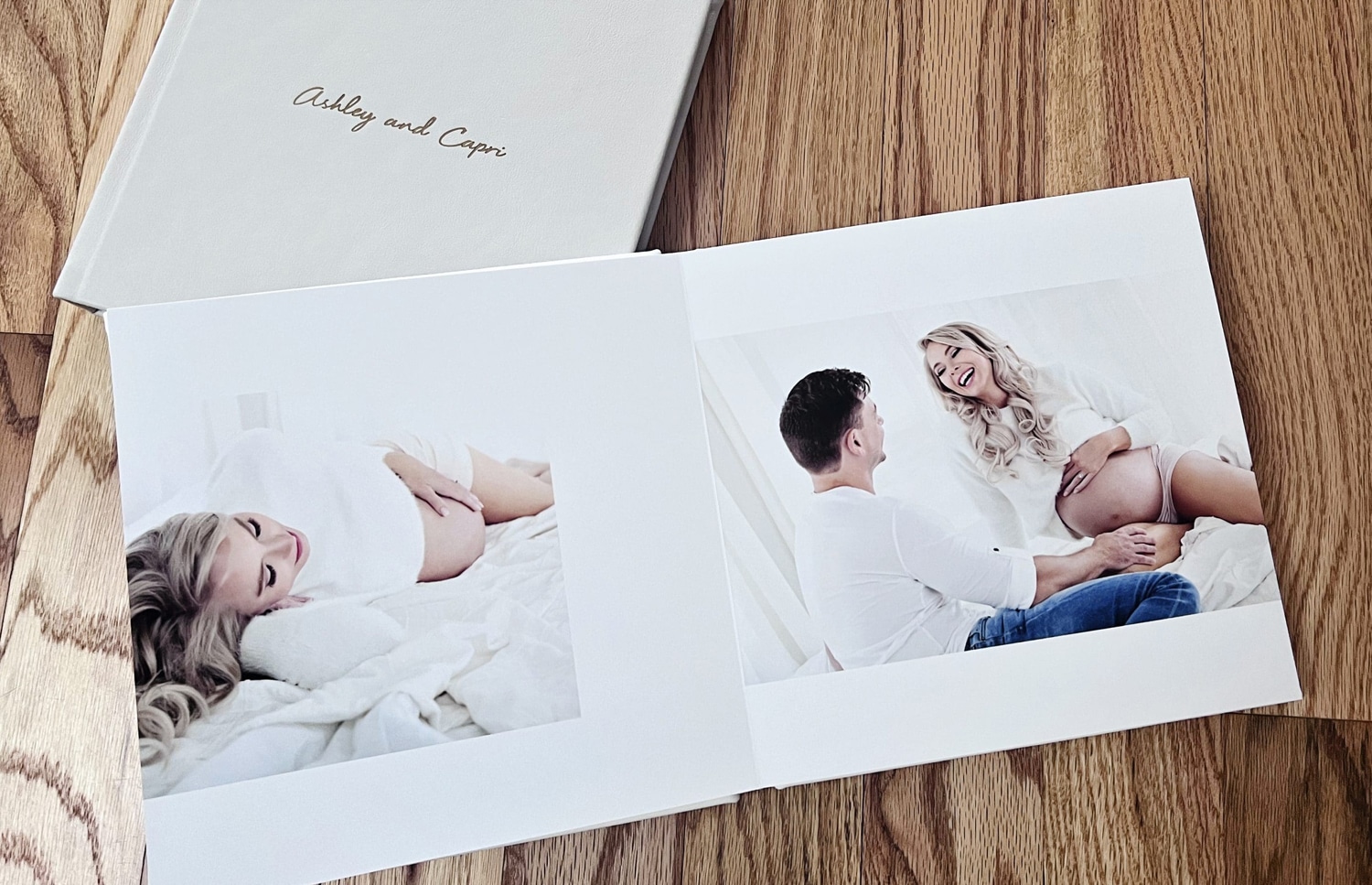A baby book with a photo of an expecting couple.