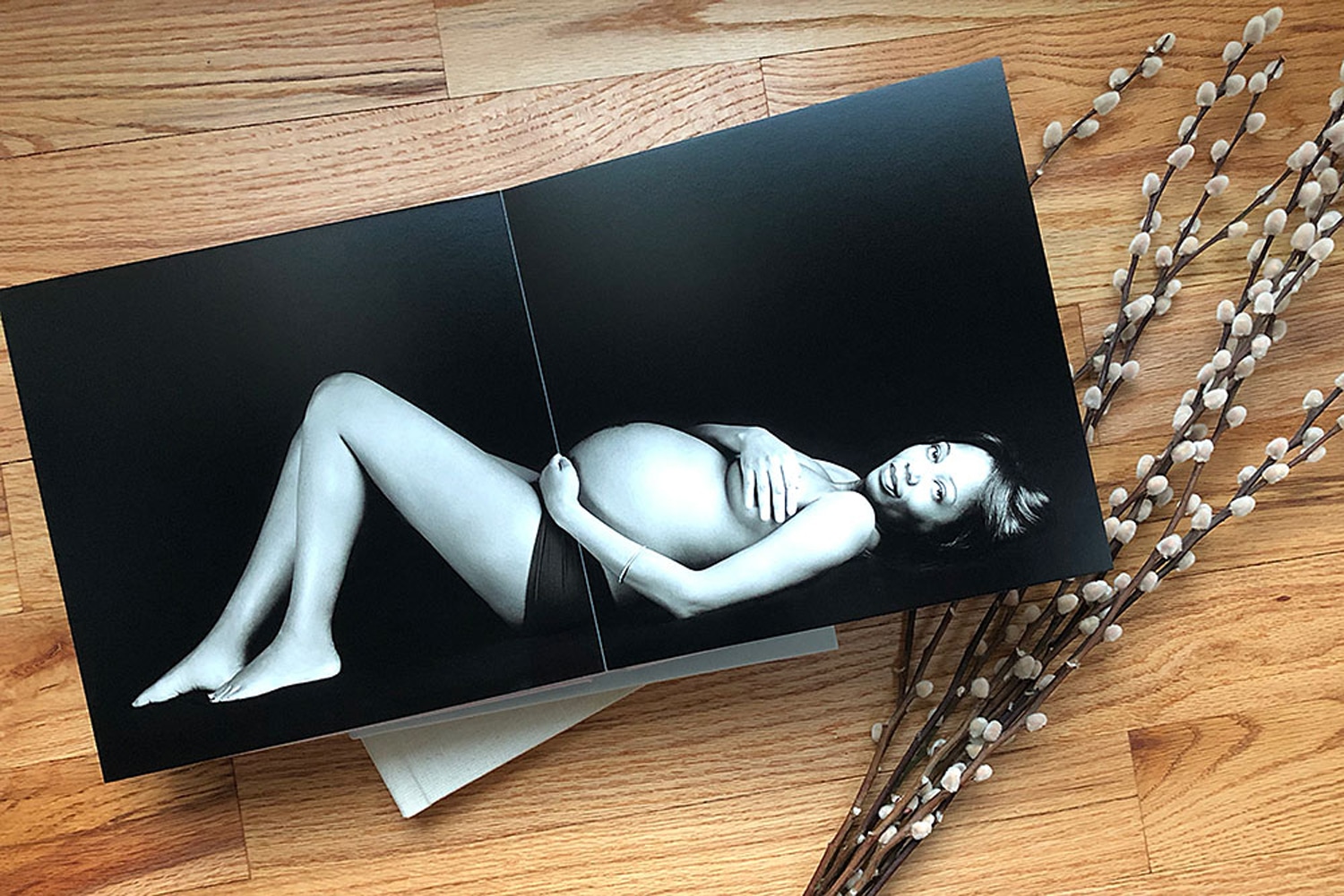 A baby book with a photo of a pregnant woman.