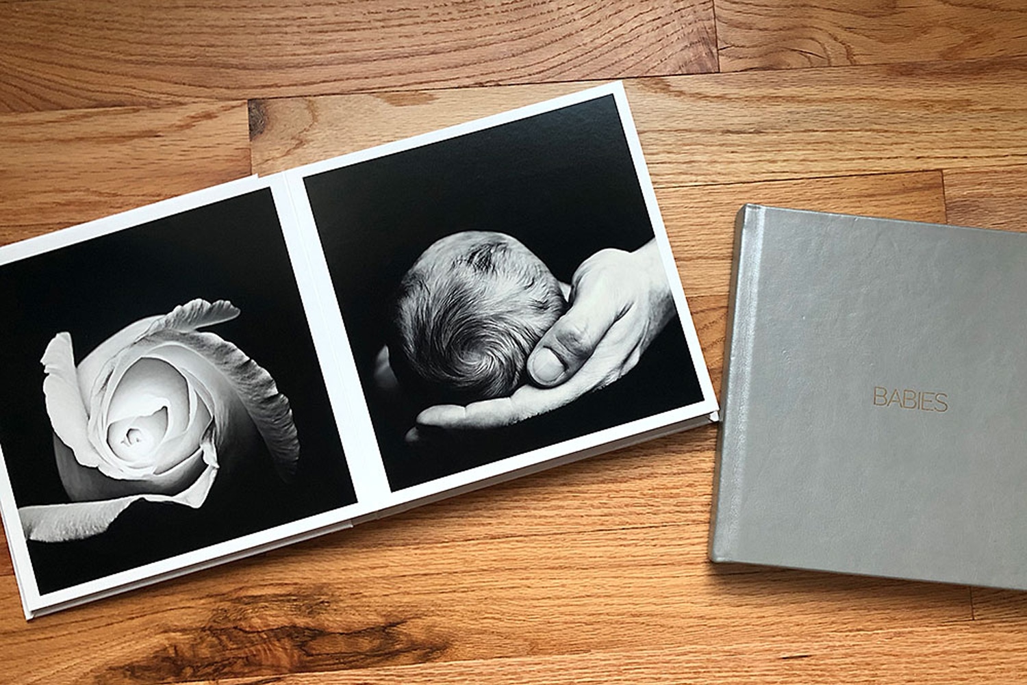 A baby book with a photo of a baby and a rose.