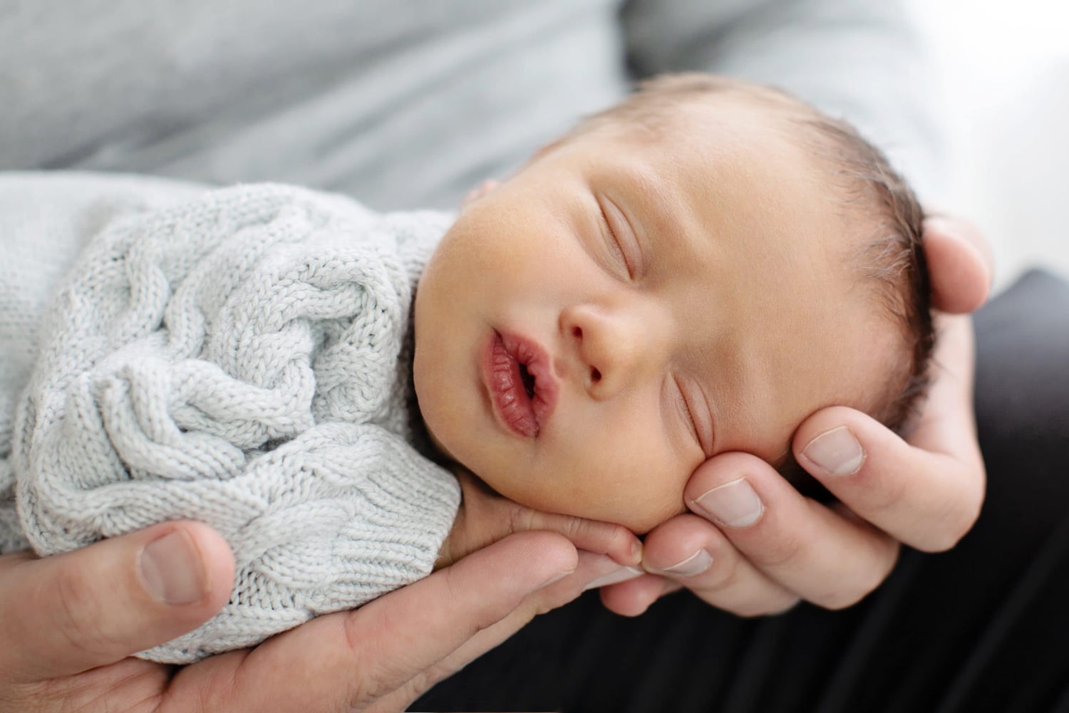 A newborn baby with pursed lips.