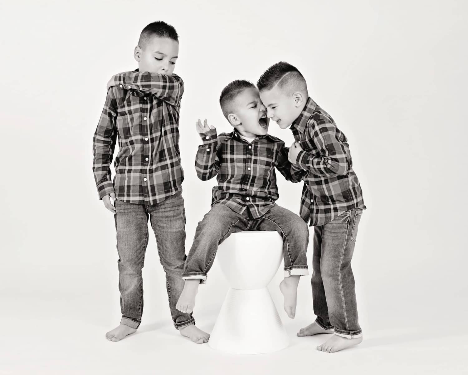 Three boys take photos in the Miette Photography studio.