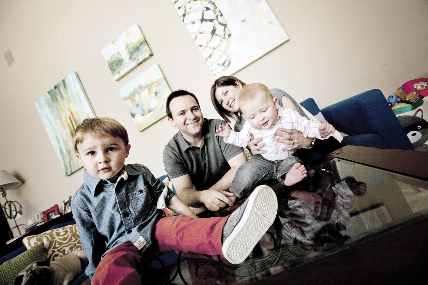 A family of four's photo is taken in their home.