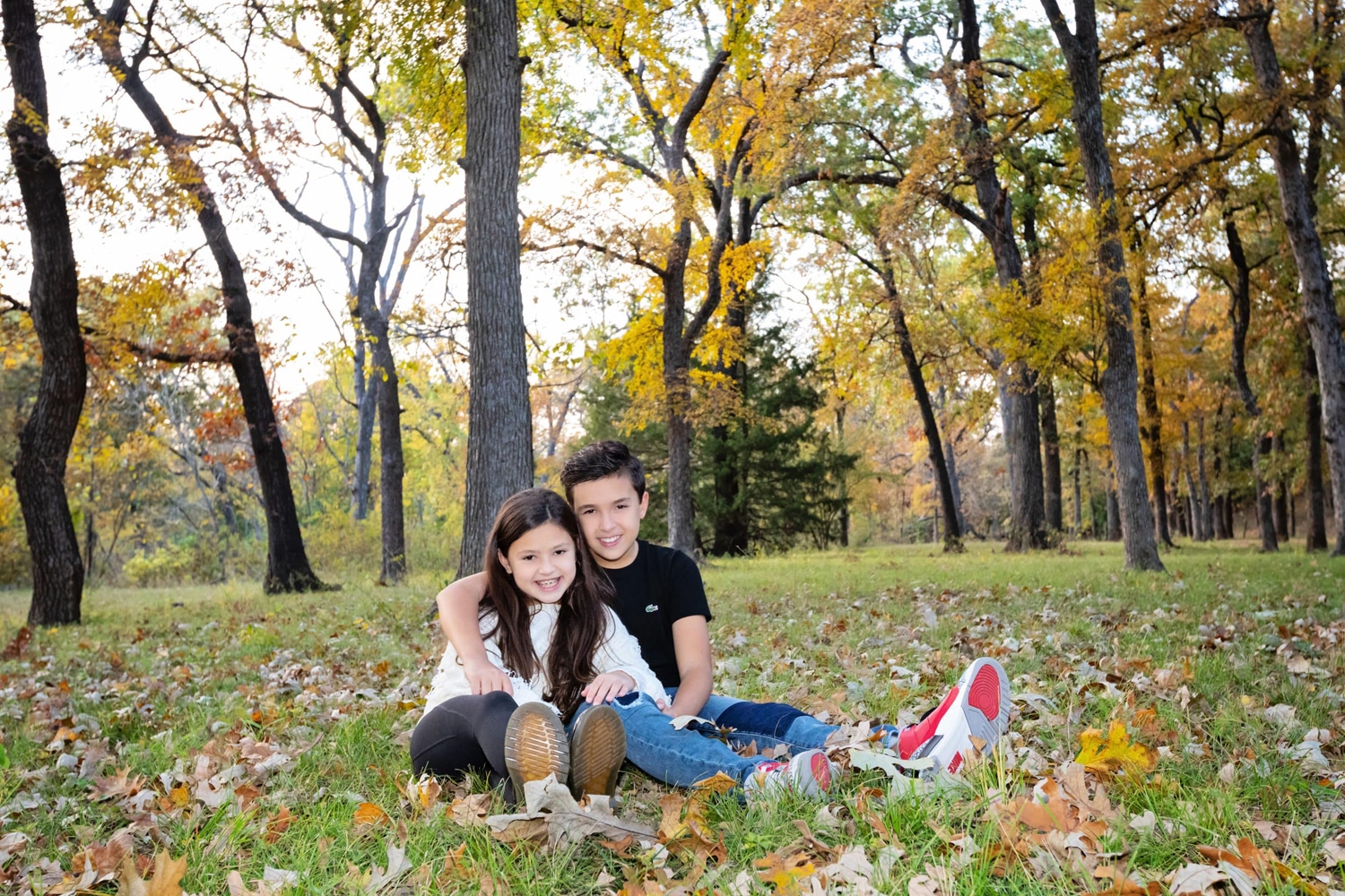 Two kids take photos outside.