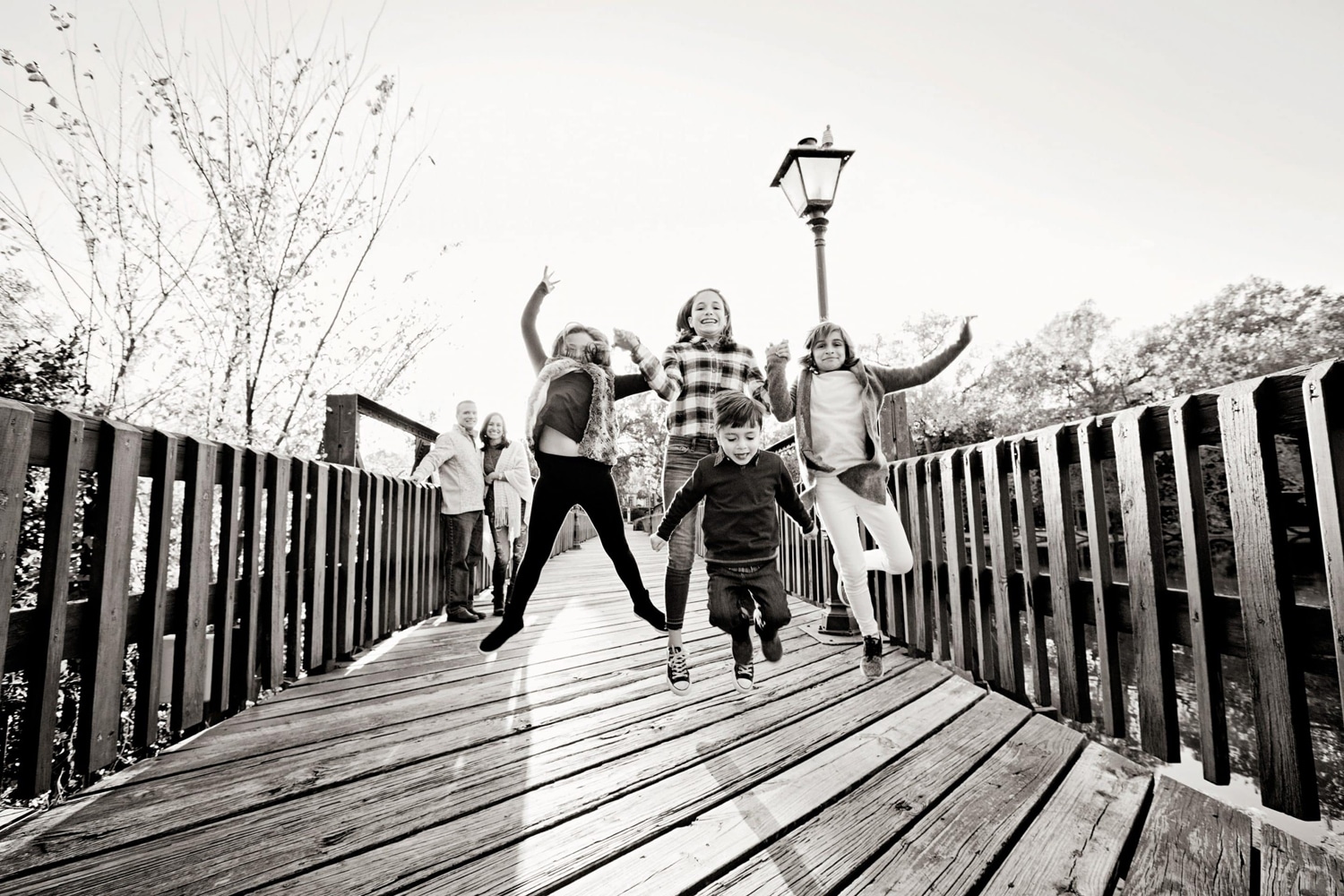 A family of six takes photos outside.