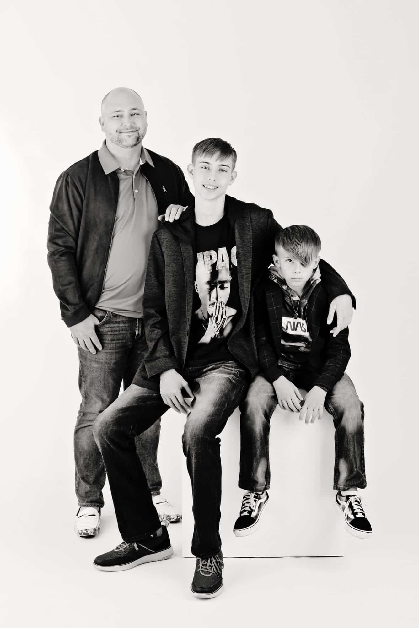 Two boys and their dad take photos in the Miette Photography studio.
