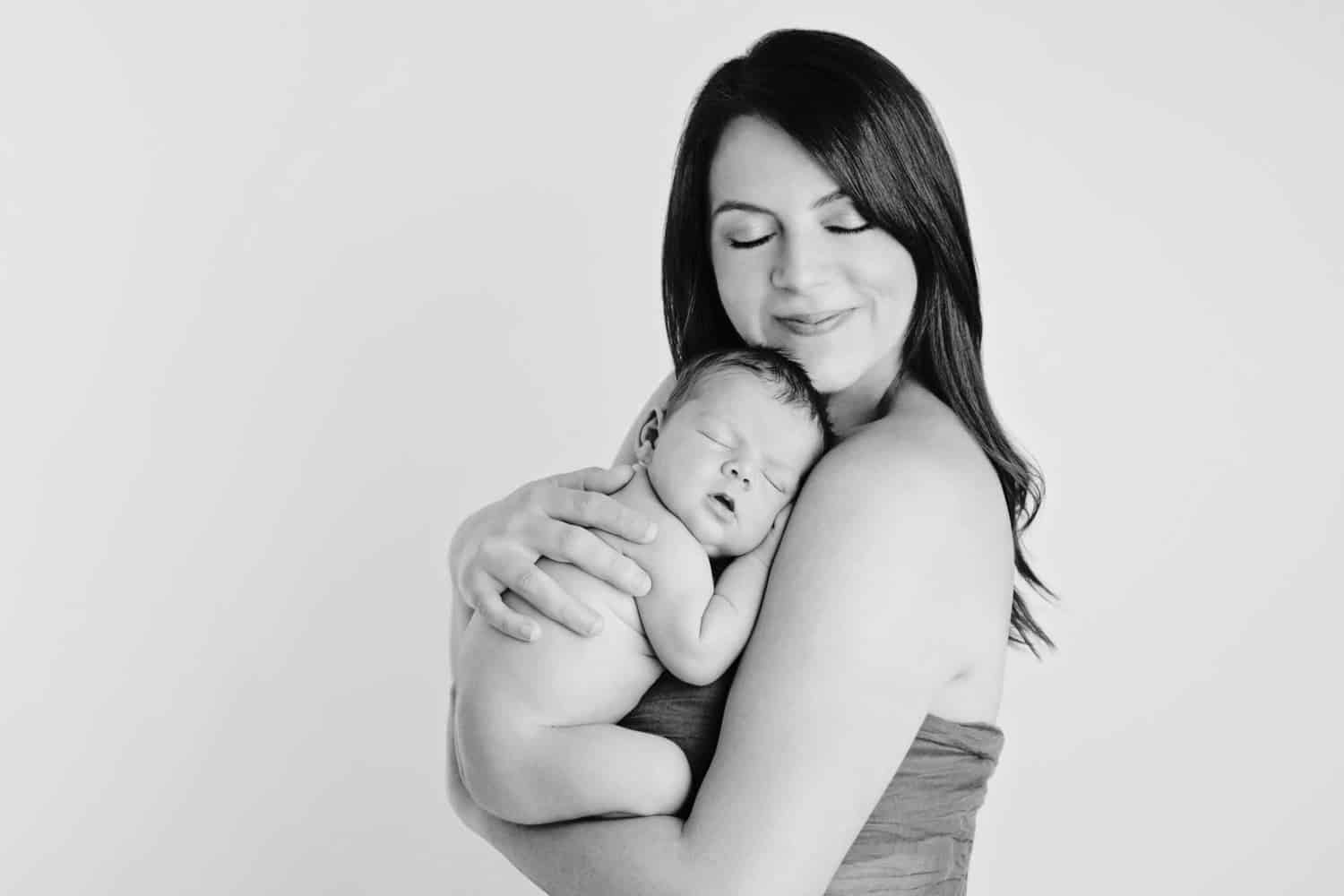 Black and white photo of a mom and her newborn baby.