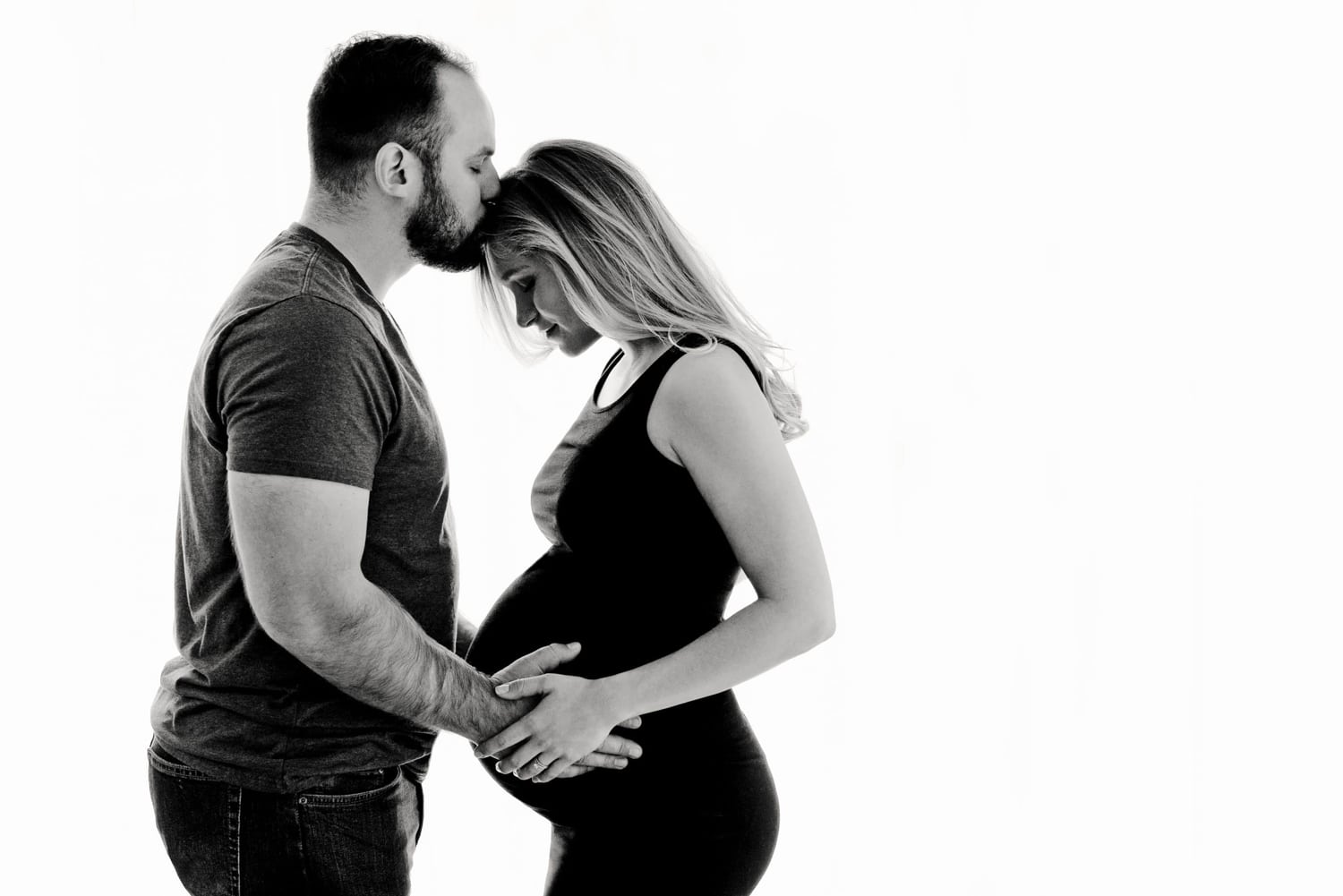 An expecting couple in a maternity portrait.