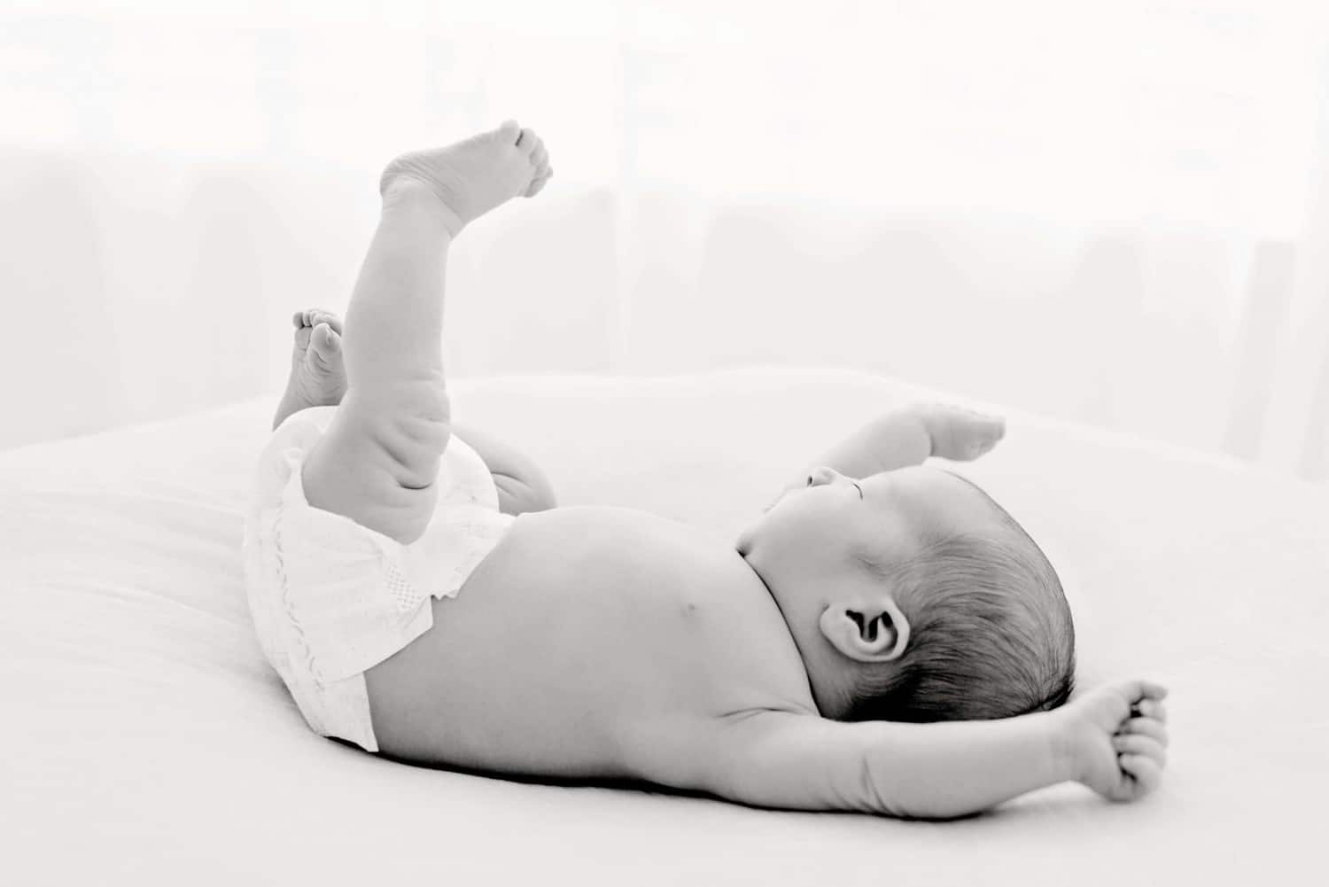 A black and white minimalist newborn photo.