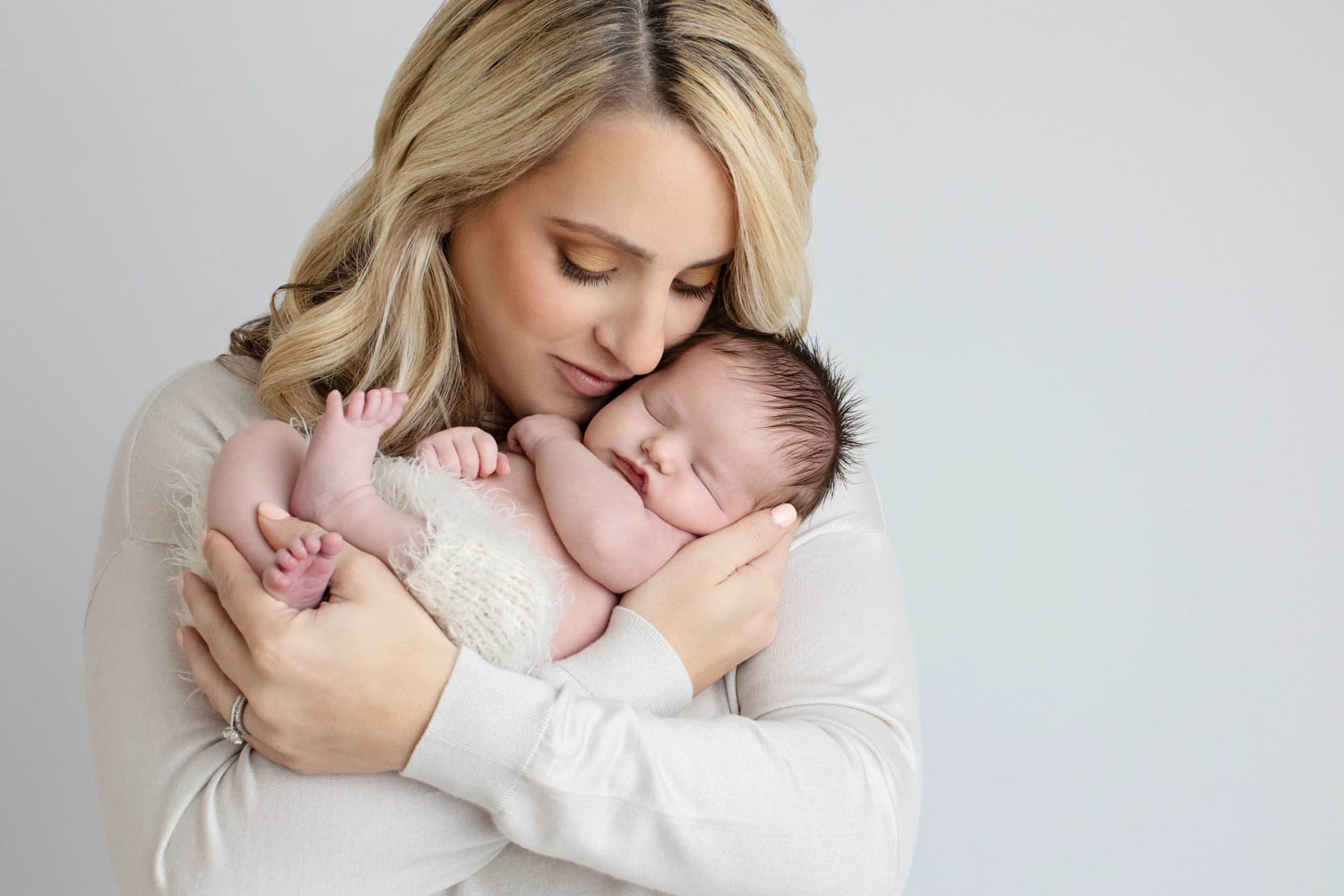 A woman holds her newborn baby.