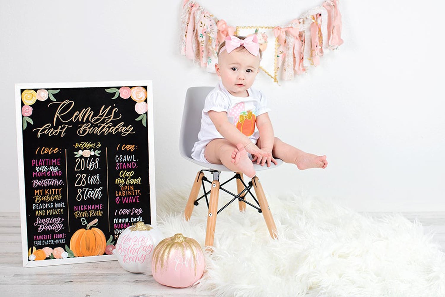 A baby celebrates her first birthday with decorations.
