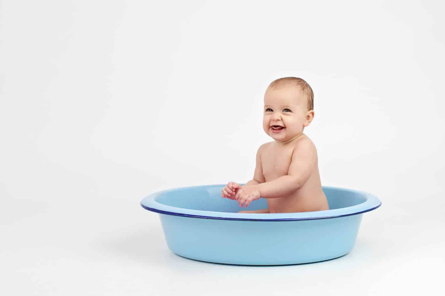 A six-month-old in a bathtub.