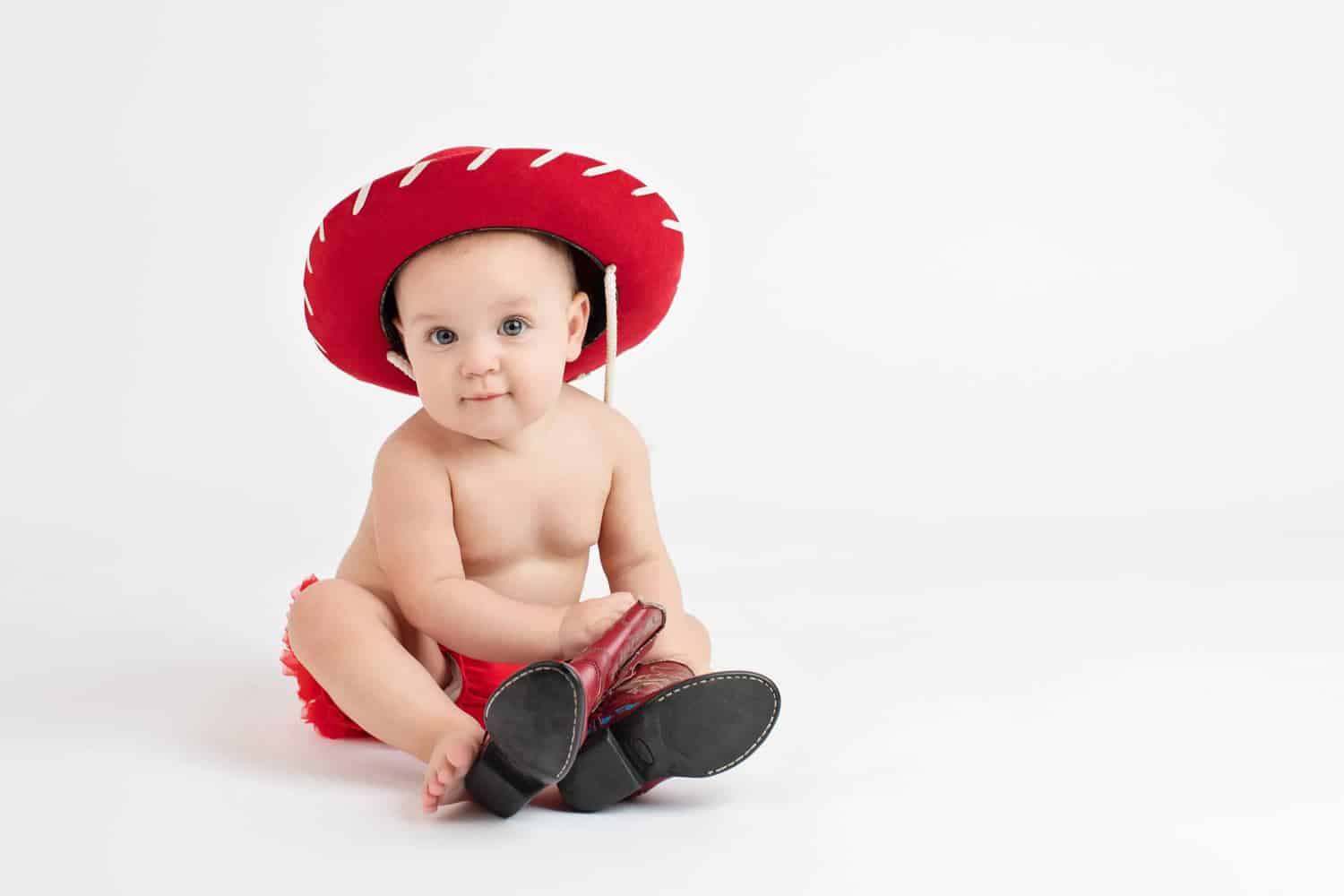 A six-month-old in a red cowboy hat.